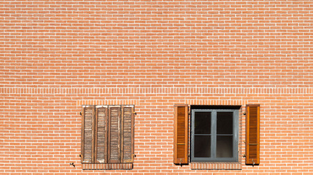facade of a building with two windows, brick wallの写真素材
