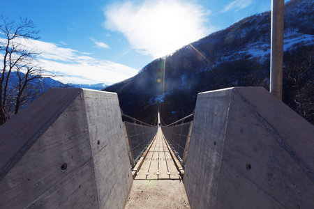 Mountain landscape with suspension bridge over the valleyの写真素材