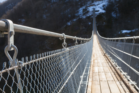 Mountain landscape with suspension bridge over the valleyの写真素材