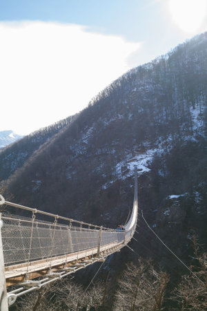 Mountain landscape with suspension bridge over the valleyの写真素材