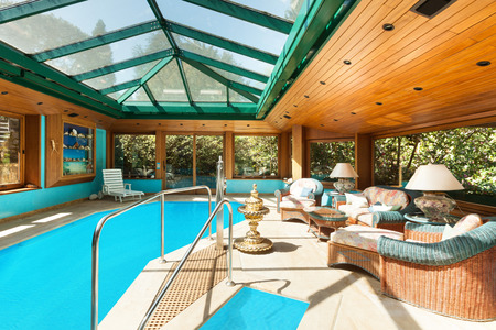Interior of a residential house, large indoor pool, ceiling with skylightsの写真素材