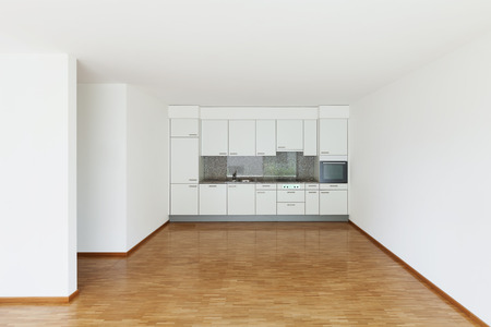 interior of an apartment, empty living room with kitchen, parquet floorの写真素材