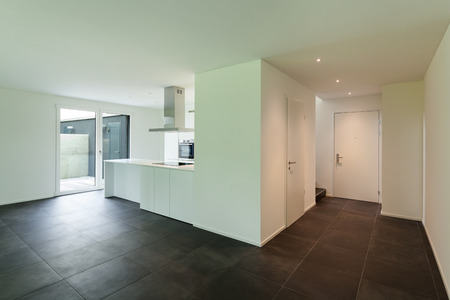 interior of empty apartment, wide room with kitchenの写真素材