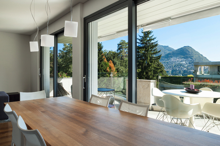 Interior of modern house, dining room with wooden tableの写真素材