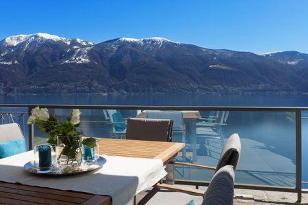 Terrace of house with dining table and lake viewの写真素材