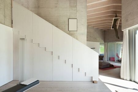 Interior of a modern loft, wide room with stair, concrete wallsの写真素材
