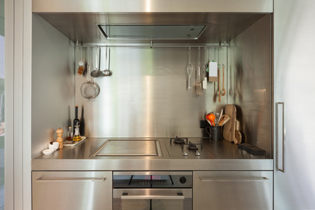 Domestic stainless steel kitchen, hob with objectsの写真素材