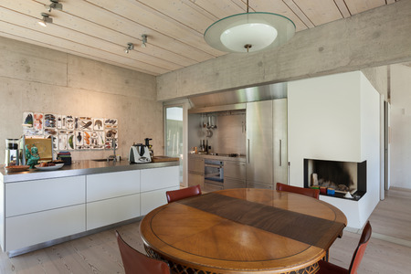Interior of a villa, modern kitchen with wooden table, concrete wallsの写真素材