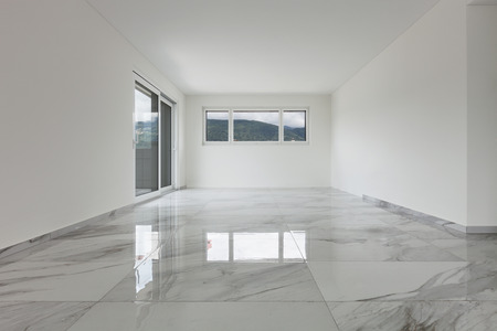 Interior of empty apartment, wide room with marble floor