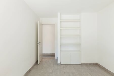 Room with bookcase of empty apartment, interiorの写真素材