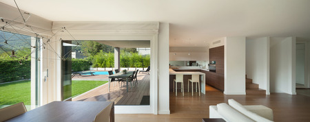Luxury home interior, wide open space, veranda and garden view from the windowsの写真素材