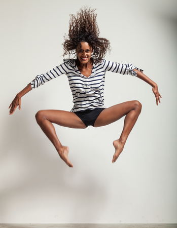 young beautiful dancer posing on a studio backgroundの写真素材