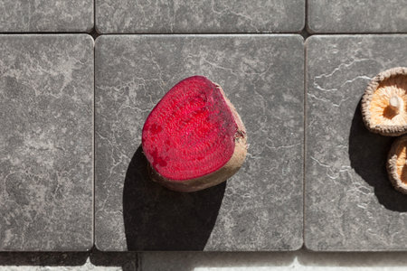Closeup of a beet section, gray tiles in background