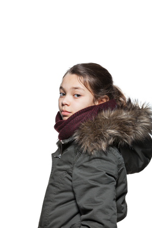 Girl wearing winter coat with the fur hood, isolated on white backgroundの写真素材