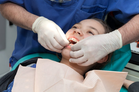 Dental care concept, girl by her dentist to revise the dental appliance
