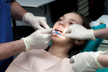 Dental care concept, girl by her dentist to revise the dental applianceの写真素材