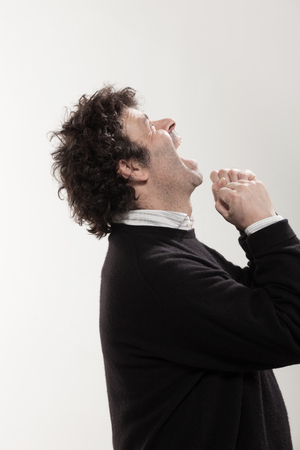 Portrait of adult man with curly hair and black sweater, side viewの写真素材