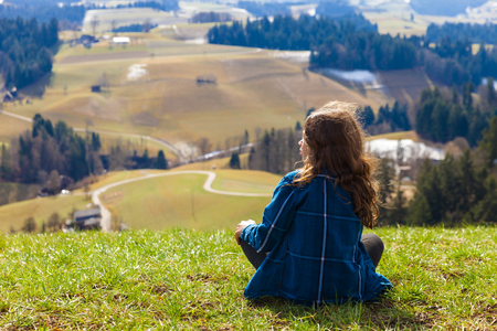 Girl watching the mountain landscapeの写真素材