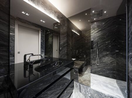 Interior of modern bathroom with black marbleの写真素材