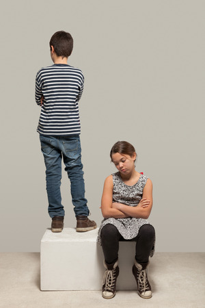 portrait of two children in studio, isolated on gray backgroundの写真素材
