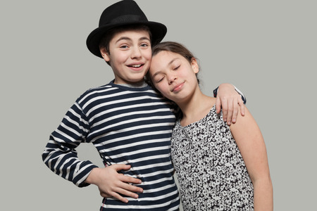 Nice couple of teens dressing retro clothing, portrait in studioの写真素材