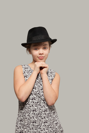 Sweet girl with black hat wearing a dress, portraitの写真素材