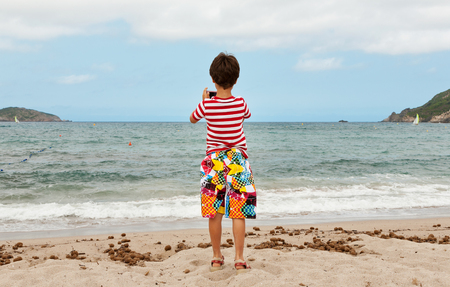 portrait of boy on the beach, rear viewの写真素材