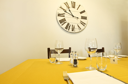 dining table and clock on the wallの写真素材