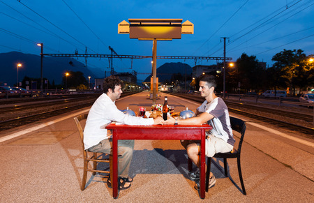 Portrait of Couple of men, dinner in stationの写真素材