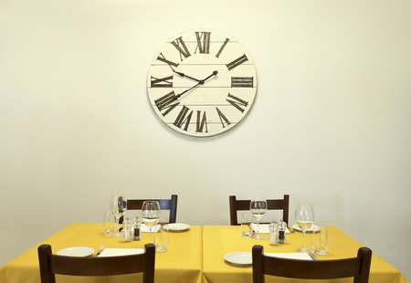 dining table and clock on the wallの写真素材
