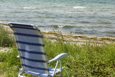 There is only one chair on the deserted beach of northern Europeの写真素材