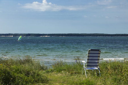There is only one chair on the deserted beach of northern Europeの写真素材