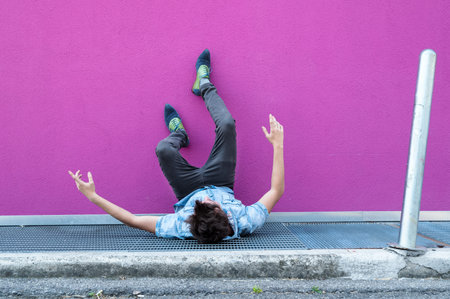 Young man fall on grill. Fuchsia background