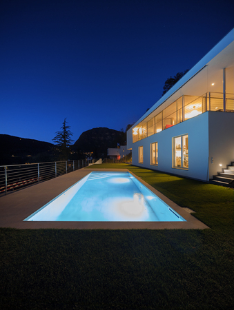 Modern house, exterior in the night, lights onの写真素材
