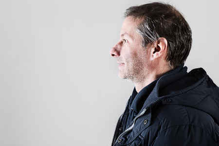 portrait of middle-aged man in studio on white backgroundの写真素材