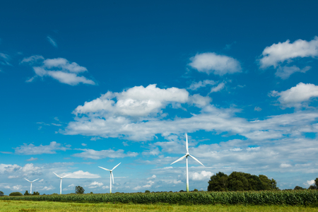 wind blade surrounded by green fieldsの写真素材