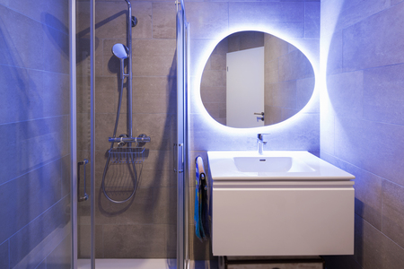 Modern marble bathroom with backlit mirror. Relaxing light. Nobody insideの写真素材