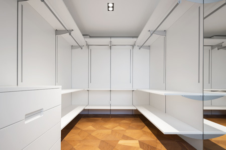 Large white walk-in closet with parquet. Nobody inside, copy spaceの写真素材