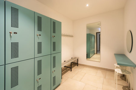 Dressing room with turquoise lockers. Benches to change outfit. Nobody insideの写真素材