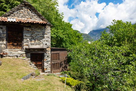 Stone hut in a large flower garden. Nobody insideの写真素材