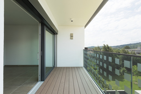 Balcony of modern apartment with white walls, nobody in the sceneの写真素材