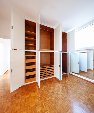 Room with wardrobe, parquet and a mirror. Nobody insideの写真素材