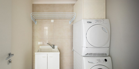 Laundry room with modern washer and dryer, nobody insideの写真素材