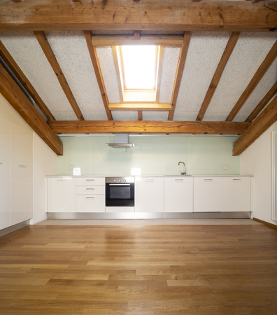 Kitchen in empty apartment with wooden beams. Nobody insideの写真素材