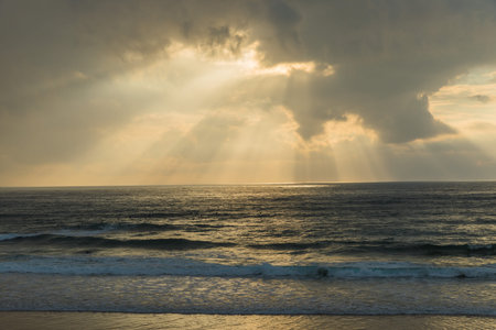 Sunset behind clouds. Atlantic ocean