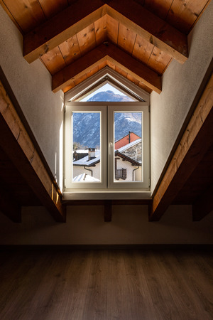 Window detail with a view of Swiss snow-capped mountains. Nobody insideの写真素材