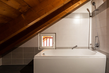 Detail of bathtube in the attic, wooden beams. Nobody insideの写真素材