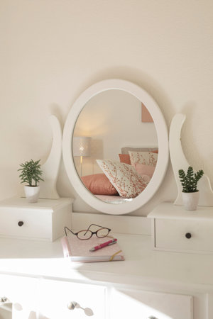 Detail of makeup dressing table with large mirror, diary and organizer. White and clean workstation...