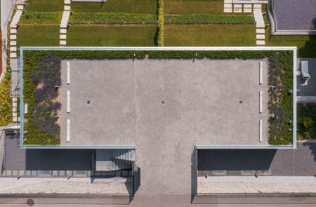 Top view of modern house with garden. There is a parking lot with lavender on the roof. The grass is green. No person insideの写真素材