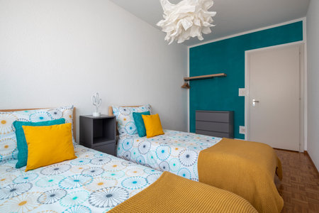 Spacious room for children with two single beds, colored sheets and lots of pillows. Nobody inside